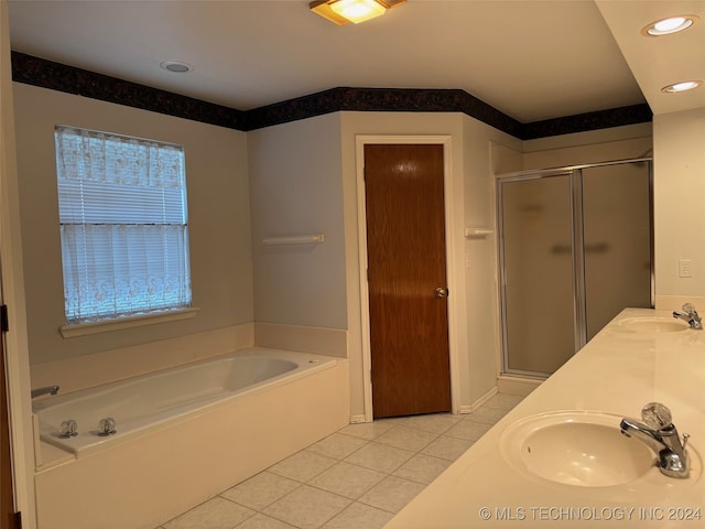 bathroom featuring tile patterned flooring, shower with separate bathtub, and vanity