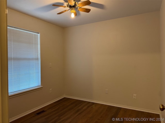 spare room featuring dark hardwood / wood-style flooring and ceiling fan