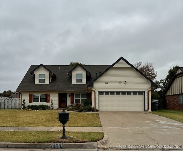 cape cod home with a front lawn and a garage