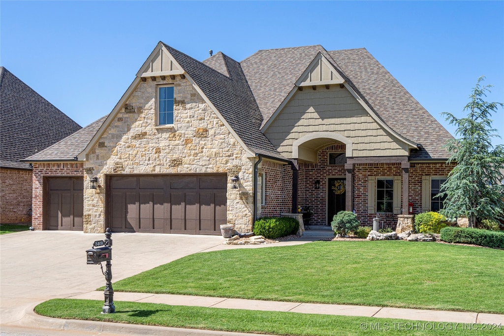 view of front of home featuring a garage and a front lawn