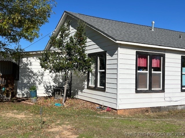 view of property exterior with a yard