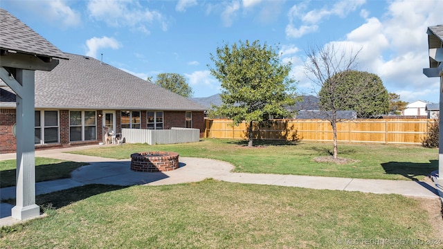 view of yard featuring a patio area and a fire pit