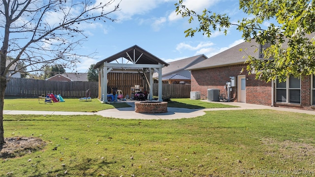 view of yard with a gazebo, an outdoor fire pit, a patio, and central AC