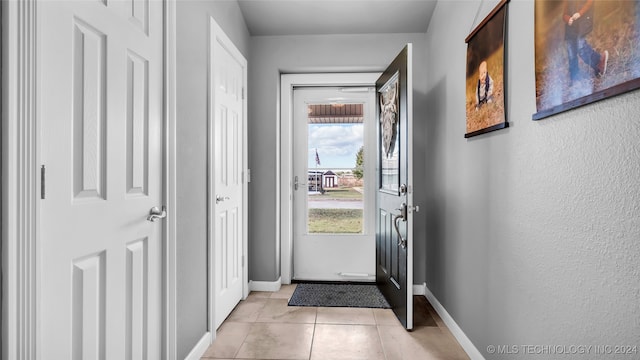 entryway with light tile patterned floors