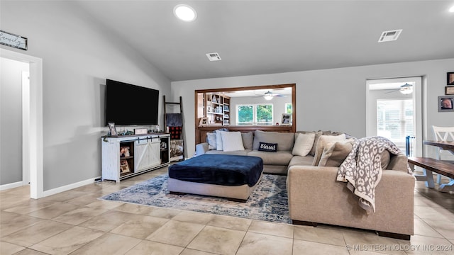 tiled living room with ceiling fan, lofted ceiling, and a wealth of natural light