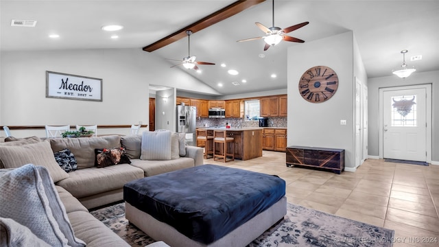 tiled living room with ceiling fan, beam ceiling, and high vaulted ceiling