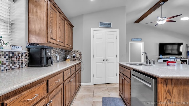 kitchen with tasteful backsplash, stainless steel dishwasher, sink, vaulted ceiling with beams, and a kitchen island