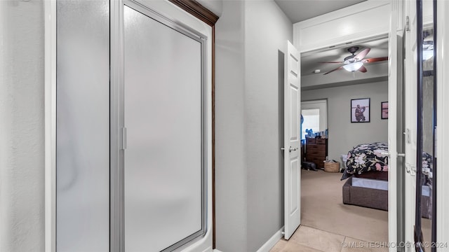 corridor featuring light tile patterned floors