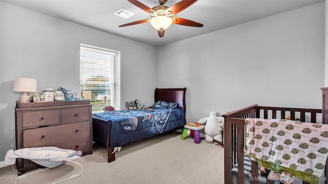 carpeted bedroom with ceiling fan