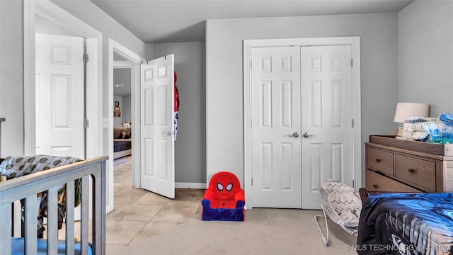 bedroom featuring a closet and light tile patterned flooring