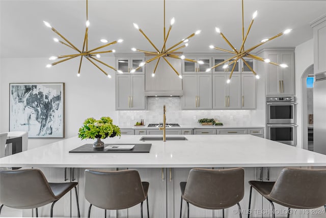 kitchen featuring pendant lighting, stainless steel appliances, and an inviting chandelier