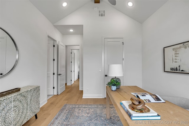 office area with ceiling fan, light wood-type flooring, and high vaulted ceiling