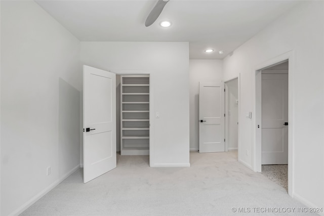 unfurnished bedroom with light carpet and ceiling fan