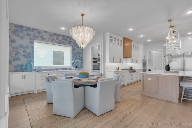 dining room featuring a notable chandelier and light hardwood / wood-style flooring