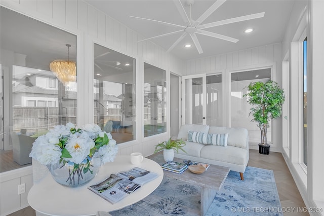 sunroom / solarium featuring an inviting chandelier