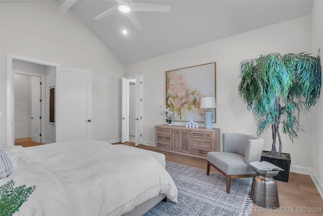 bedroom featuring beamed ceiling, ceiling fan, light hardwood / wood-style flooring, and high vaulted ceiling