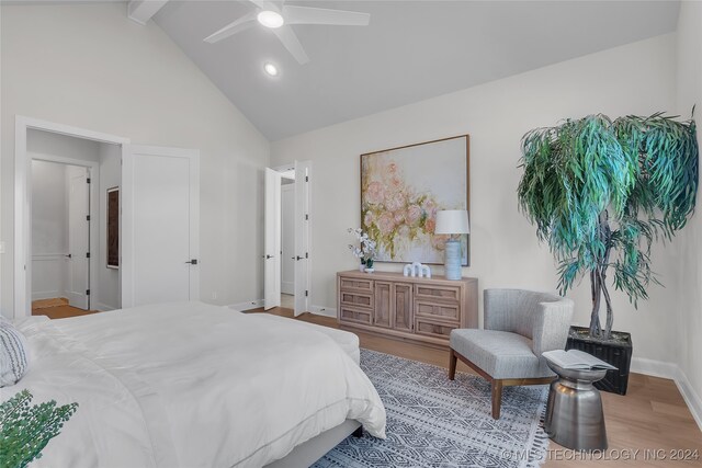 bedroom featuring high vaulted ceiling, light hardwood / wood-style floors, beamed ceiling, and ceiling fan