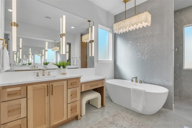 bathroom with plus walk in shower, vanity, a notable chandelier, and plenty of natural light