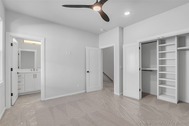 unfurnished bedroom with connected bathroom, light colored carpet, and ceiling fan