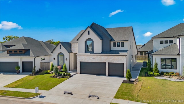 view of front of property featuring a garage, central AC, and a front yard