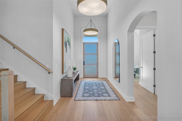 entrance foyer with light hardwood / wood-style floors and a high ceiling