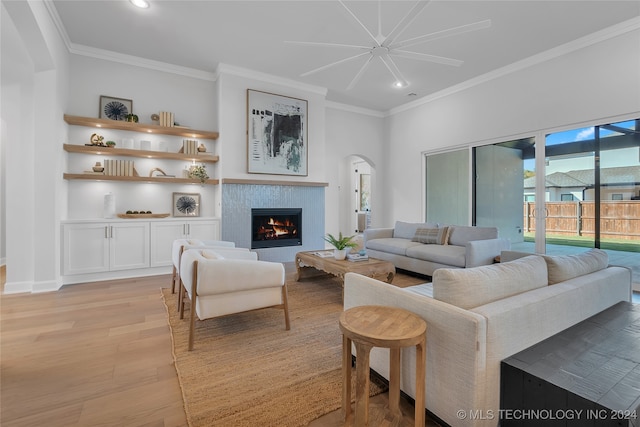 living room featuring crown molding and light hardwood / wood-style flooring