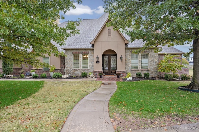 view of front of house with a front yard and french doors