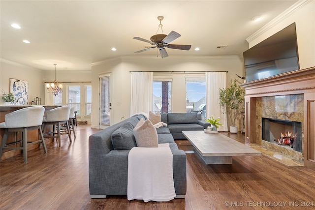 living room with dark hardwood / wood-style flooring, crown molding, and plenty of natural light