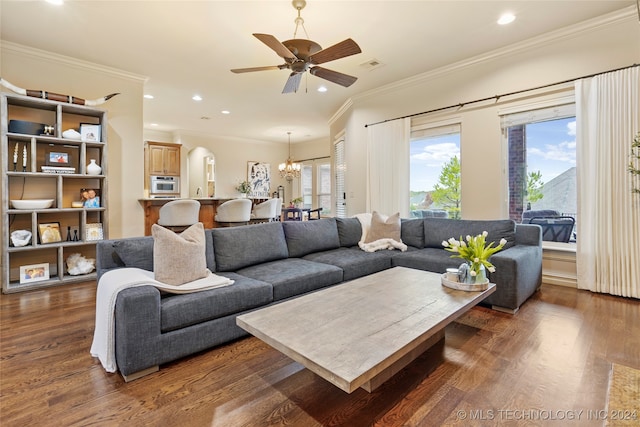 living room featuring ornamental molding, dark hardwood / wood-style floors, and ceiling fan with notable chandelier