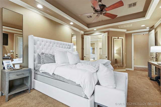 carpeted bedroom featuring ceiling fan, a raised ceiling, and ornamental molding