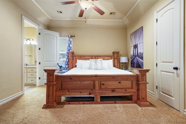 bedroom featuring ornamental molding, ensuite bath, ceiling fan, and light colored carpet