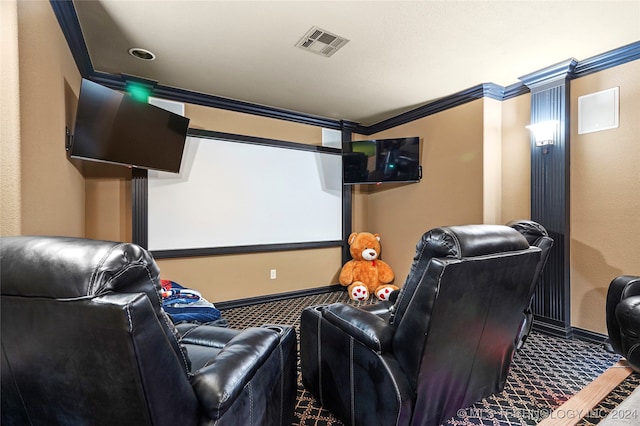 carpeted cinema featuring ornamental molding