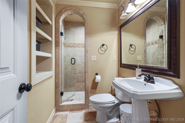 bathroom with a shower with door, toilet, and crown molding