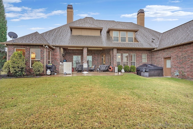 rear view of property with a patio and a yard