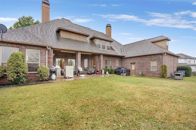 back of house featuring a yard and a patio