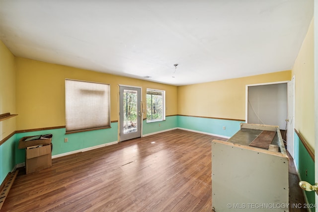 unfurnished living room with dark hardwood / wood-style flooring