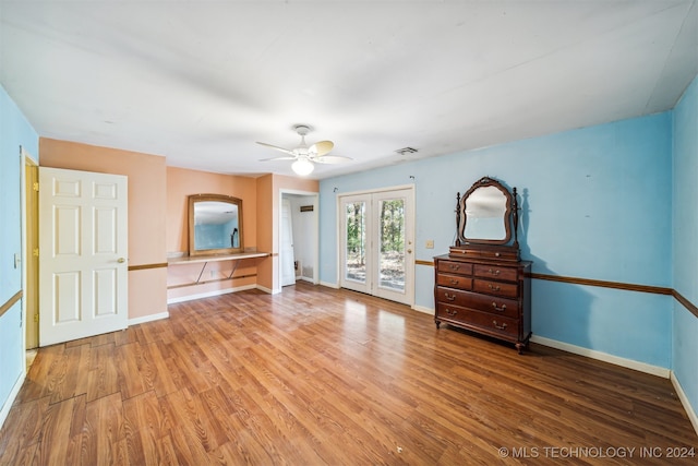 unfurnished bedroom with access to outside, wood-type flooring, and ceiling fan