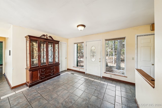 entryway featuring dark tile patterned floors