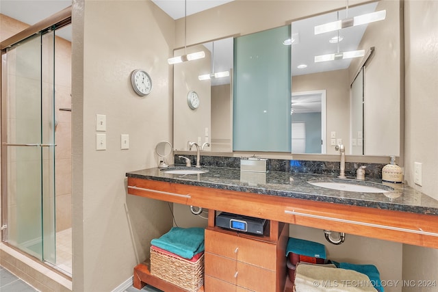 bathroom featuring vanity and a shower with door