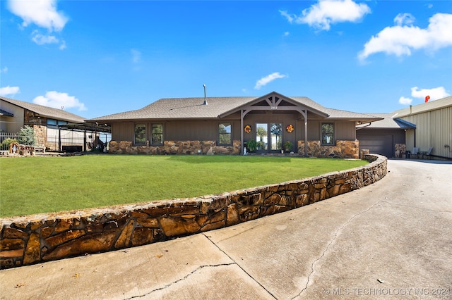 ranch-style home featuring a garage and a front yard