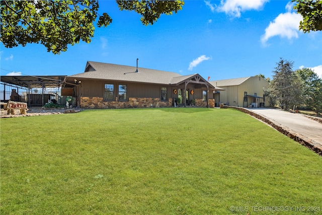 single story home featuring a front lawn and a carport