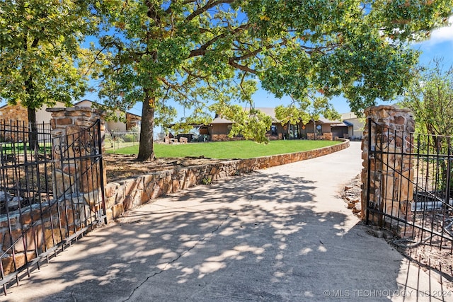 view of gate featuring a yard