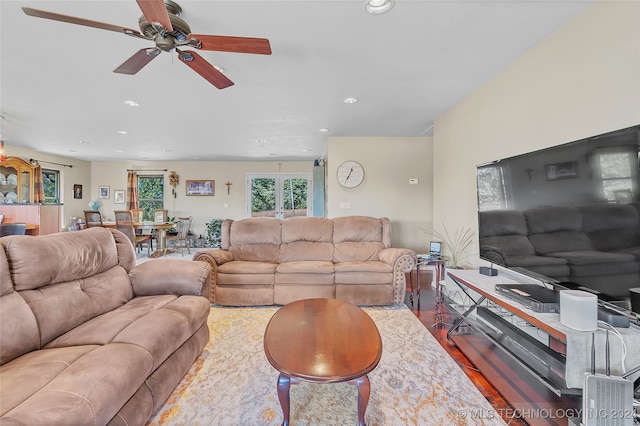 living room featuring hardwood / wood-style floors and ceiling fan