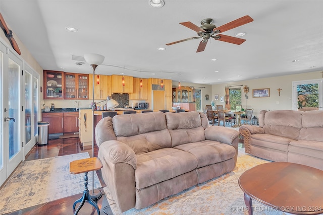 living room with ceiling fan and wood-type flooring