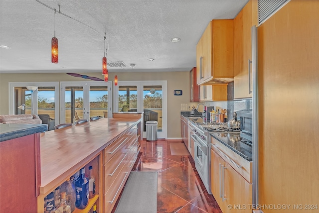 kitchen featuring stainless steel appliances, a healthy amount of sunlight, sink, and french doors