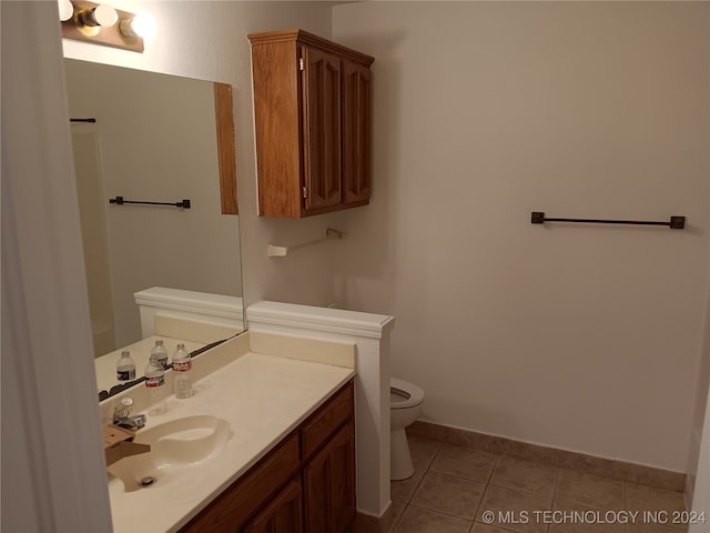 bathroom featuring toilet, vanity, and tile patterned floors