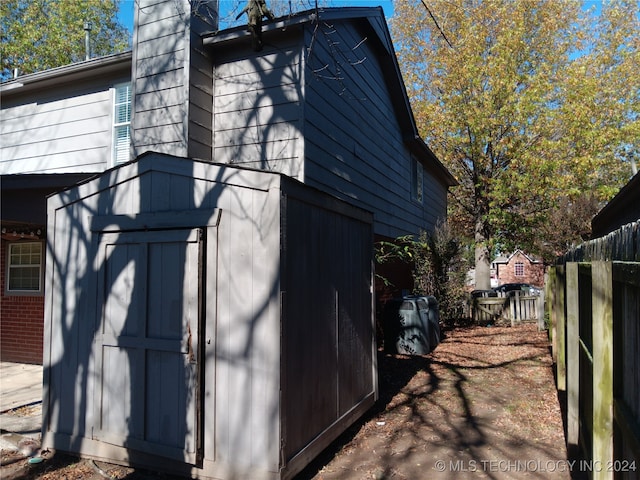 view of side of property with a shed