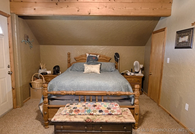 carpeted bedroom with lofted ceiling with beams