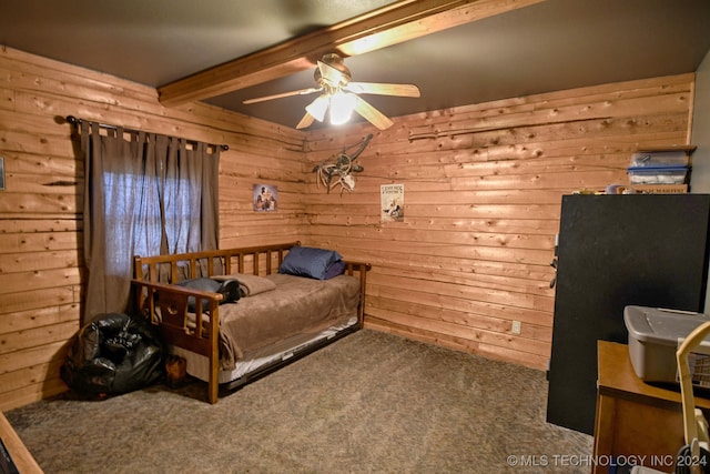 carpeted bedroom with ceiling fan, beam ceiling, and wooden walls