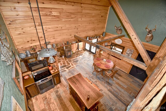 interior space with hardwood / wood-style floors and wood walls